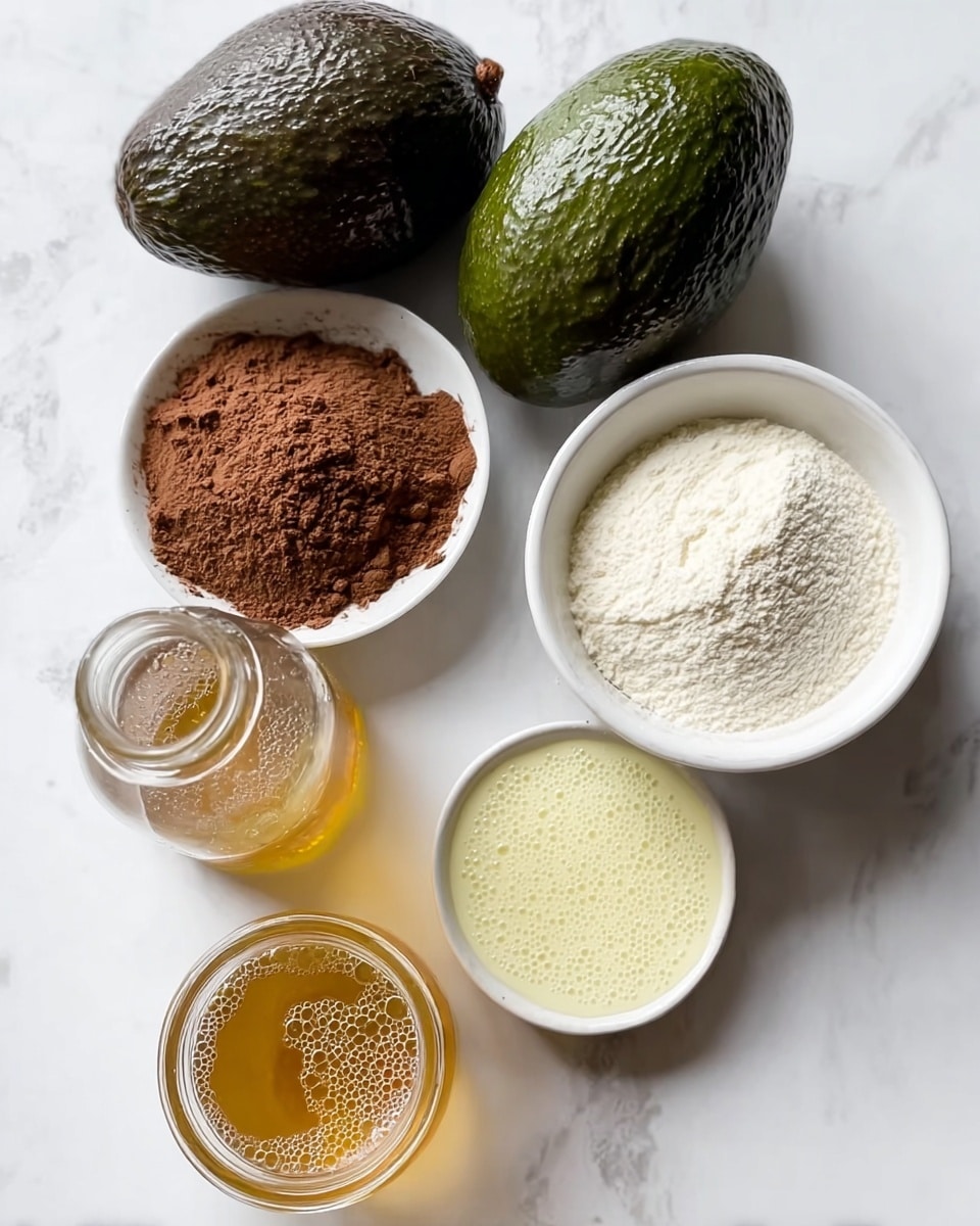 The image shows six ingredients neatly arranged on a white marbled surface. There are two whole dark green avocados placed side by side, one above the other, with bumpy skin and shiny texture. To the right, there is a small white bowl filled with coarse white powder. Above it, a round white bowl holds fine brown powder, looking smooth and rich. To the left of the brown powder, there is a small glass jar filled with light golden honey, shiny and clear. Above the honey jar, there is a small glass bottle containing creamy white liquid with bubbles on top. The colors contrast clearly with the white marbled surface, giving a clean and fresh look. photo taken with an iphone --ar 4:5 --v 7