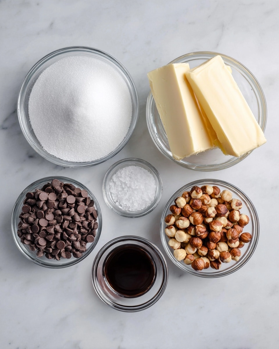 The image shows six clear glass bowls on a white marbled surface. The top bowl is filled with white granulated sugar with a smooth texture. To the left below it is a bowl with two thick rectangular pieces of pale yellow butter. Next to the butter bowl on the right is a bowl filled with light to medium brown roasted hazelnuts, showing different shades and some textures of cracks. Below the hazelnuts is a smaller bowl with white coarse salt flakes. To the left of the salt is a bowl filled with dark brown chocolate chips, round and shiny. The smallest bowl on the far right holds a little dark brown vanilla extract liquid. Each bowl is neatly arranged with enough space around them. photo taken with an iphone --ar 4:5 --v 7