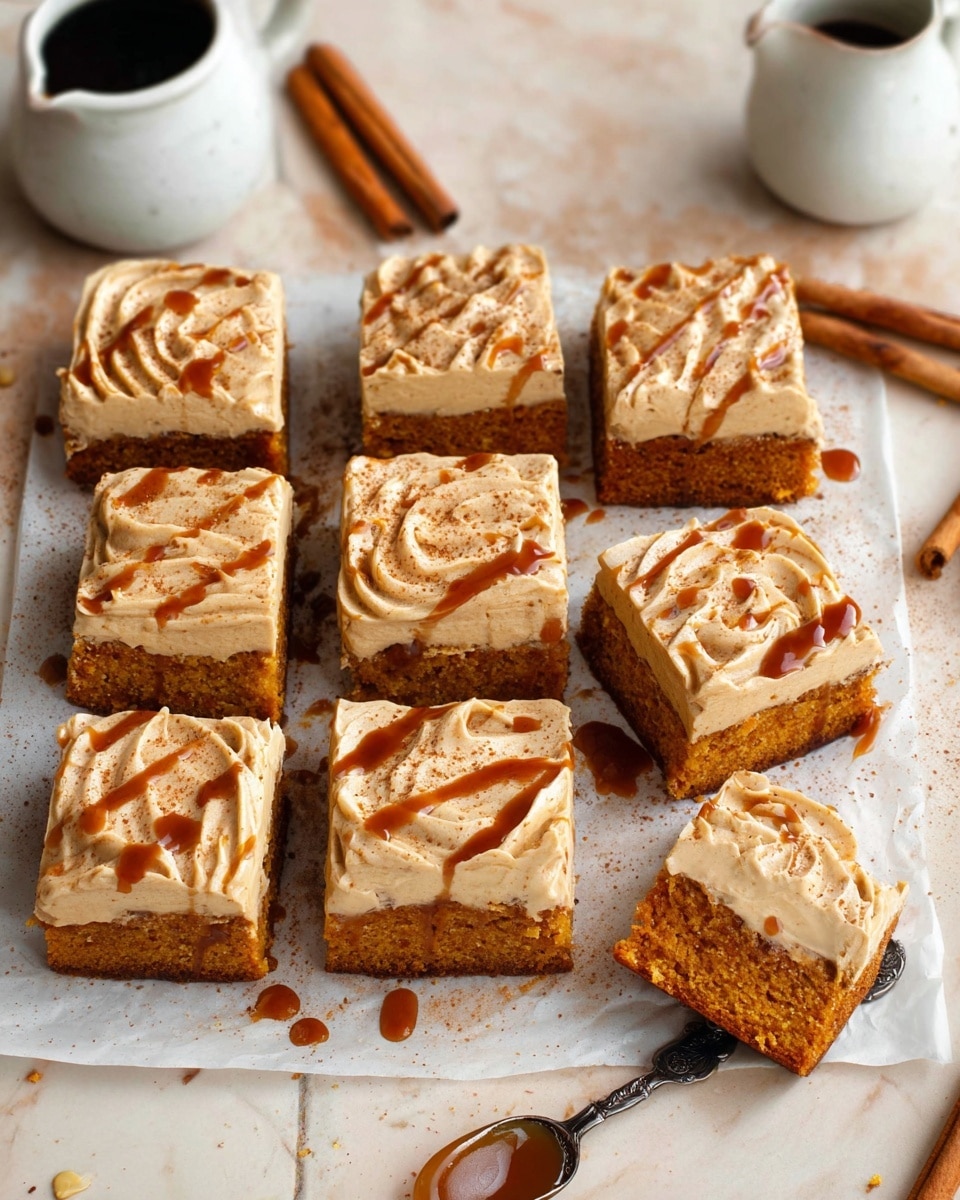The image shows eight square pieces of a cake arranged in two rows of four on white parchment paper. Each piece has two layers: a thick, moist orange base and a creamy beige frosting layer on top. The frosting is smooth with swirled patterns and is sprinkled with light brown powder, likely cinnamon. There are drizzles of dark caramel sauce scattered on the frosting of each square. One piece is slightly lifted, showing the dense texture of the orange cake. Around the cake pieces, there are cinnamon sticks and a small white jug, along with a spoon with some caramel, all placed on a white marbled surface. Photo taken with an iphone --ar 4:5 --v 7
