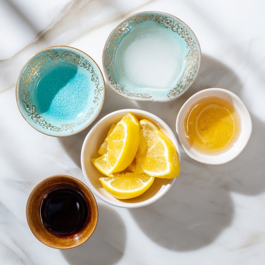The image shows five small bowls arranged on a white marbled surface. In the center, there is one white bowl filled with bright yellow lemon wedges. To the top left and bottom right are two pale turquoise bowls with a delicate pattern on the inside, one empty and the other filled with white foamy liquid. To the right of the lemon bowl is another white bowl containing a golden honey-like liquid. At the bottom left, a small brown bowl holds a dark thick liquid. The bowls are neatly spread out in a slightly curved arrangement. Photo taken with an iphone --ar 4:5 --v 7