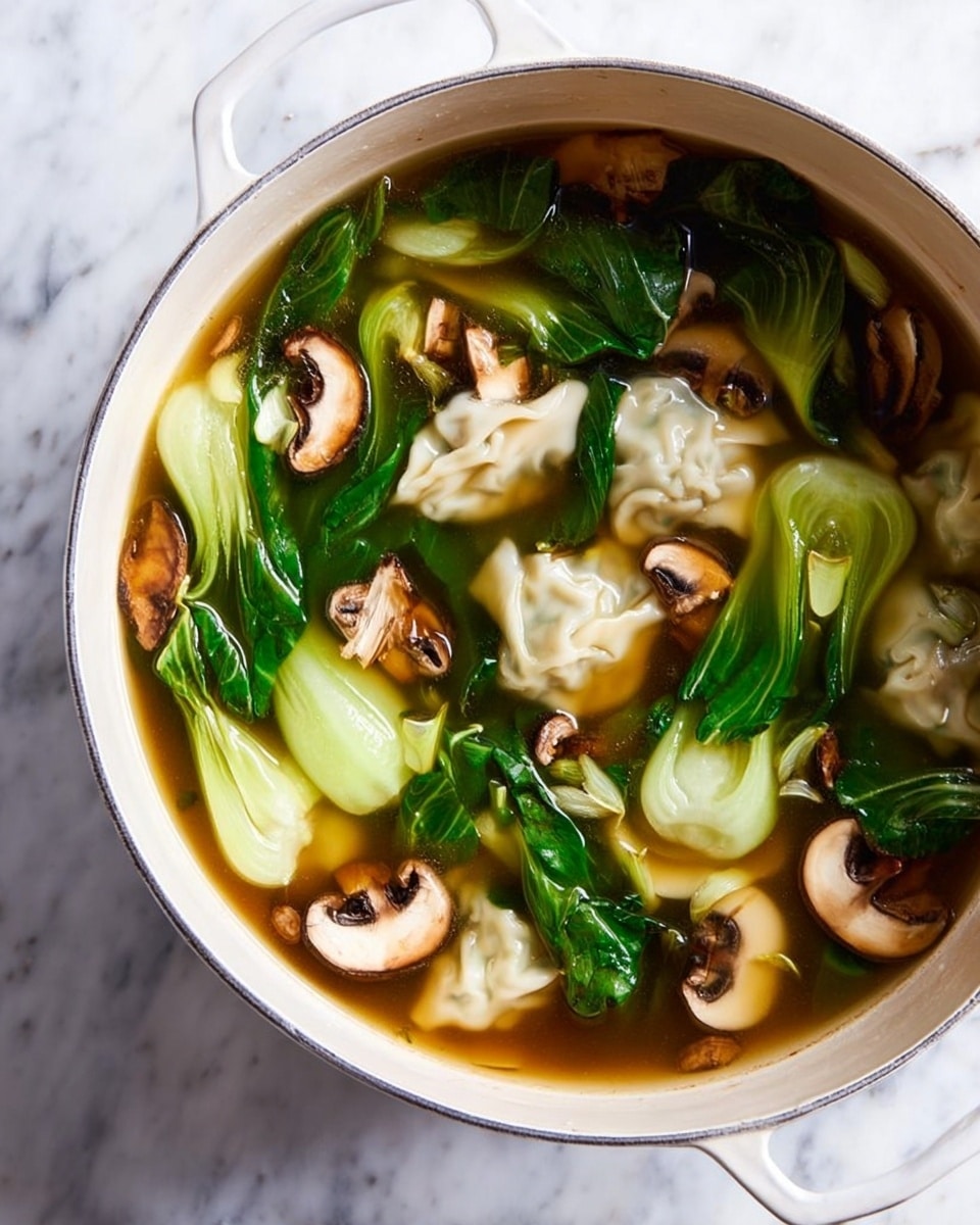 A white pot filled with a clear brown broth holds several layers, starting with soft dumplings that are pale and slightly wrinkled, floating near the bottom. On top and around the dumplings, bright green bok choy leaves and light green stalks add contrast with their smooth, shiny texture. Thinly sliced mushrooms with a light beige center and dark edges are scattered throughout, adding an earthy look. The pot sits on a white marbled surface, and the whole dish looks warm and fresh. photo taken with an iphone --ar 4:5 --v 7