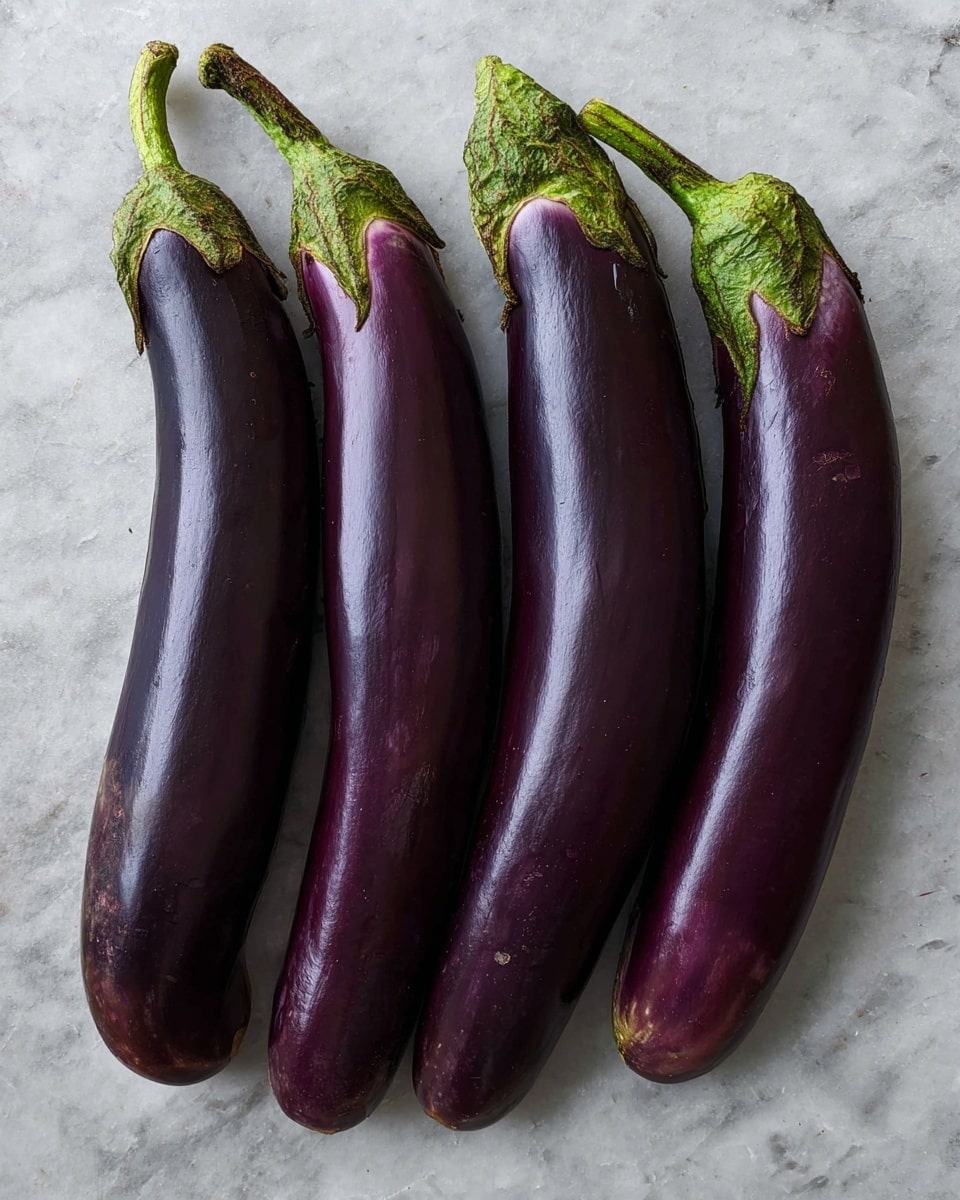 The image shows four long, slender eggplants placed side by side on a white marbled surface. Each eggplant has a deep purple skin with a smooth, shiny texture, and green tops that have a slightly rough texture. The eggplants vary slightly in curve and size, lying closely parallel to each other, creating a neat row. The background is simple, emphasizing the rich dark purple color and the natural gloss on the eggplants' skin. photo taken with an iphone --ar 4:5 --v 7