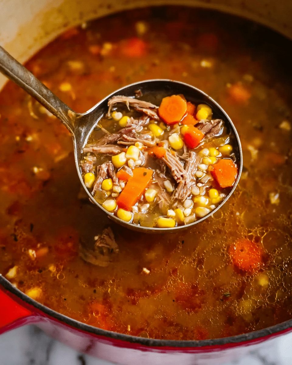 The image shows a pot full of clear brown broth soup with visible pieces of shredded meat, bright yellow corn kernels, orange carrot slices, and small grains, all stirred together with a large metal ladle. The soup looks thick with mixed chunks of vegetables and tender meat floating in the broth. The pot has a red outside with the inside edge visible, and the broth has a slightly oily surface reflecting light. The overall colors are warm and earthy, with the broth being dark brown, the corn bright yellow, carrots orange, and meat dark brown. The photo is taken close up, focusing on the ladle lifting the soup, and the background surface is a white marbled texture. photo taken with an iphone --ar 4:5 --v 7
