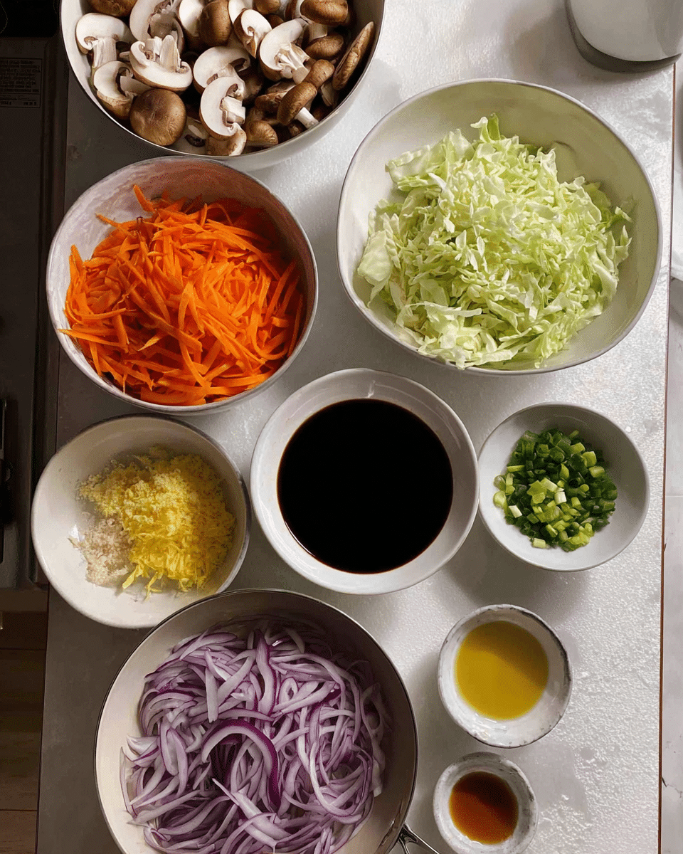 The image shows a kitchen counter with several white bowls and a pan in the front bottom. The bowls hold different sliced and chopped ingredients arranged in a loose grid. Starting from the top left, a bowl contains beige sliced mushrooms with light brown edges. To the right, a bowl is filled with light green shredded cabbage. Below the mushrooms, a bowl holds bright orange thin carrot strips. Next to that, a bowl contains three sections of finely chopped ingredients: yellow ginger, white garlic, and green chopped herbs. A smaller bowl to the right holds sliced green onions. Below the carrots, a bowl contains thinly sliced purple-red onions. In the center, a bowl filled with dark soy sauce is placed next to tiny dishes holding light-colored liquid and dark golden oil. The setting is on a counter with a white marbled texture surface. Photo taken with an iphone --ar 4:5 --v 7