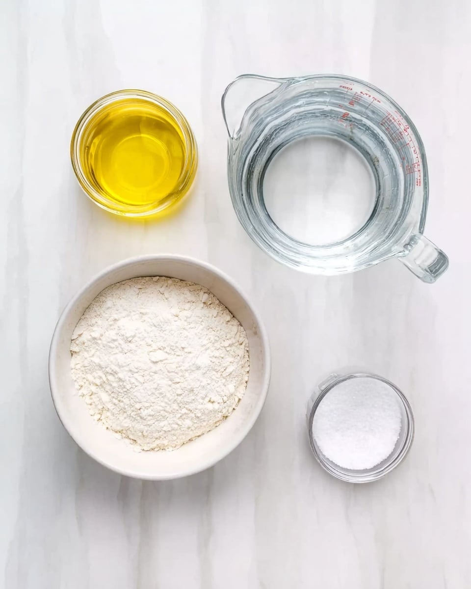 A top view of four clear glass containers on a white marbled surface, each filled with different cooking ingredients: a small jar with yellow oil on the top left, a large white bowl on the bottom left filled with white flour, a small clear bowl with white salt on the bottom right, and a clear glass measuring jug containing water on the top right photo taken with an iphone --ar 4:5 --v 7