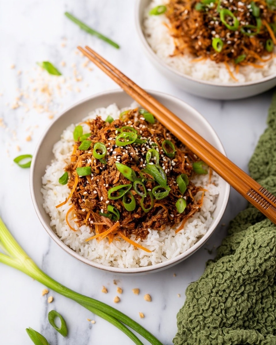 Two round white bowls filled with white rice as the bottom layer. On top of the rice is a layer of shredded brown cooked meat mixed with thin carrot strips. This brown layer is garnished with chopped green onions and sprinkled with white sesame seeds. One bowl is fully visible with a pair of wooden chopsticks resting on its edge, while the other bowl is partially shown on the right side. The bowls sit on a white marbled surface with scattered green onion pieces and sesame seeds around. A green textured cloth is in the background. photo taken with an iphone --ar 4:5 --v 7