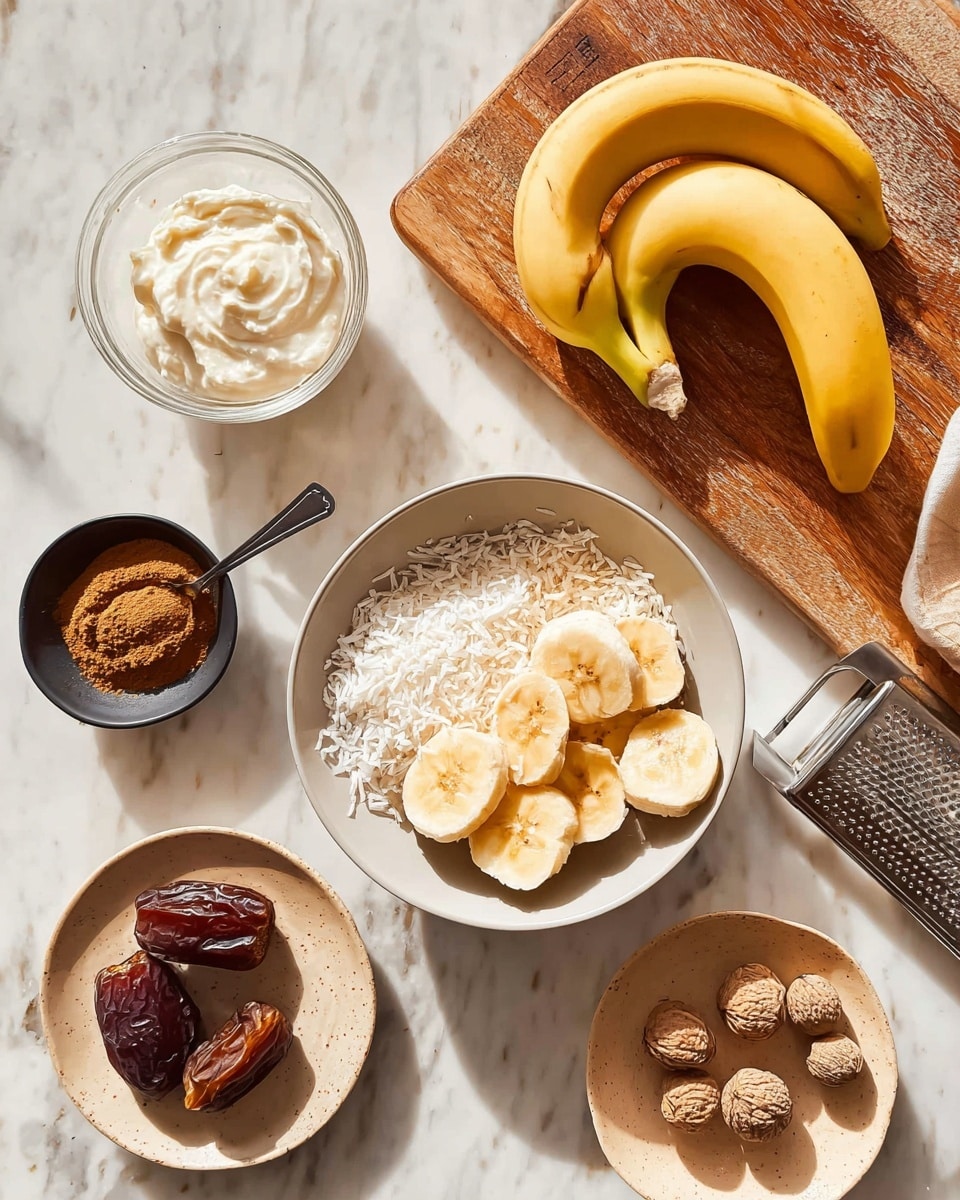 The image shows several ingredients arranged on a white marbled surface with a wooden board in the upper right corner holding two whole yellow bananas and a white bowl filled with shredded coconut. Below the board is a light gray bowl containing thick banana slices with light brown edges and creamy centers. To the left of the bowl is a small black bowl of brown powder, possibly cinnamon, with a spoon. Above this bowl is a clear glass dish with a creamy white substance, likely yogurt or cream. Next to it is a small round beige plate holding three dark brown dates, and to the right is a small beige dish with three whole nutmegs next to some grated nutmeg on a metal grater. The setting is bright and natural, with soft shadows, and no woman's hand is visible. Photo taken with an iphone --ar 4:5 --v 7