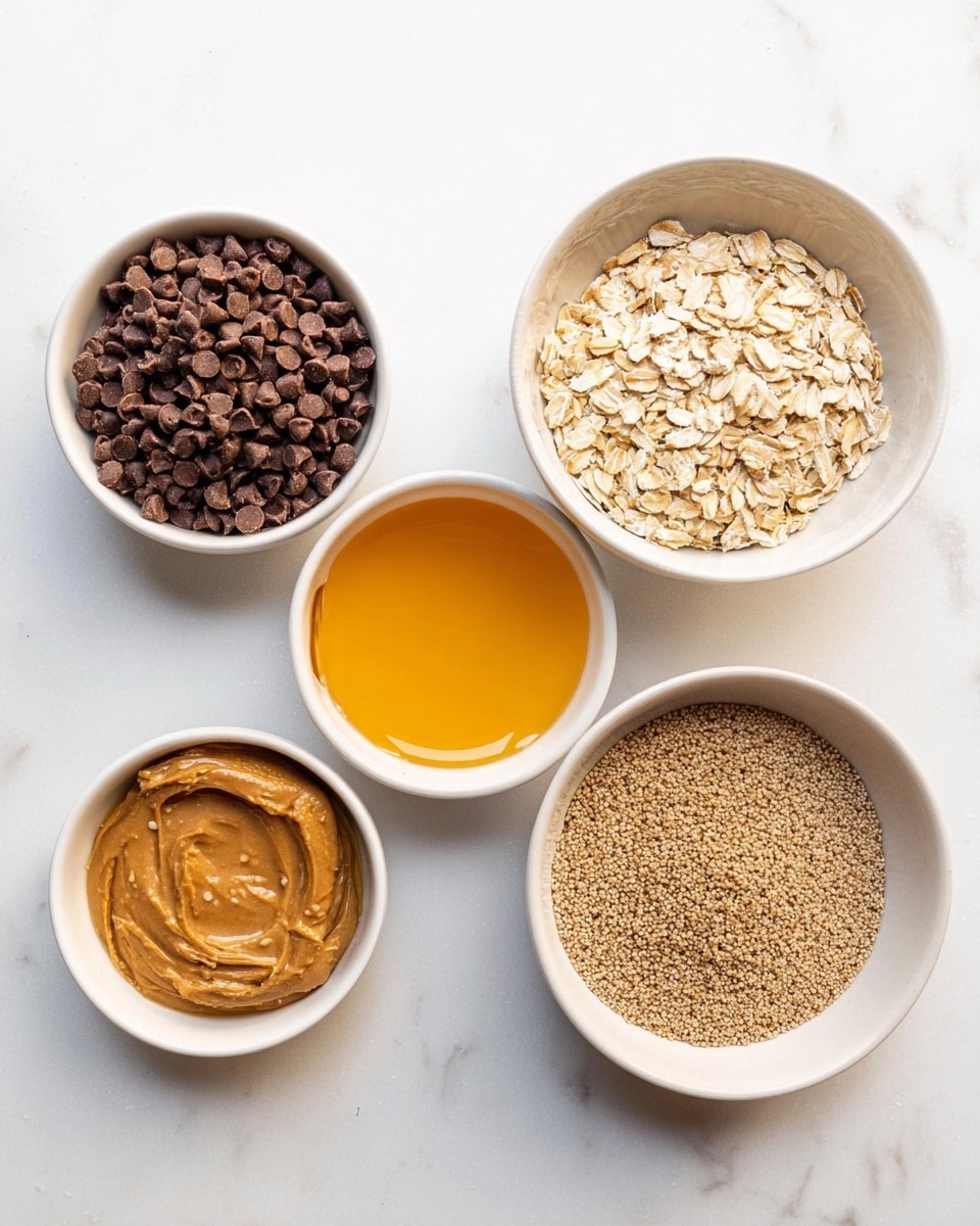 Five small white bowls sit on a white marbled surface, each holding a different ingredient. Starting from the top left, one bowl contains dark brown chocolate chips with a smooth, shiny texture. To its right, the second bowl holds a golden yellow liquid honey, clear and thick. The bowl in the center displays dry, pale beige rolled oats with a rough texture, filling it evenly. On the far right, another bowl holds a fine, light brown flaxseed meal, smooth and powdery. Lastly, at the bottom left, a bowl contains creamy peanut butter with a rich light brown color and smooth texture. Photo taken with an iphone --ar 4:5 --v 7