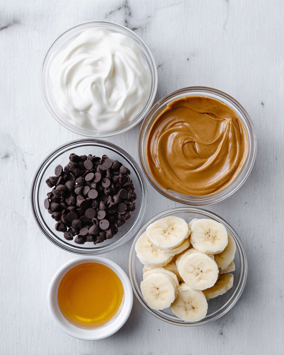 There are five clear glass bowls and one small white bowl arranged on a white marbled surface. The top left bowl holds smooth, thick, white yogurt with soft swirls. The top right bowl contains a brown, creamy peanut butter sauce that looks silky. Below them, a bowl on the left is filled with small, shiny, dark chocolate chips. Next to it on the right, there's a bowl with banana slices, each piece pale yellow with a soft texture and light brown spots in the center. The small white bowl at the bottom left holds golden honey with a shiny surface. photo taken with an iphone --ar 4:5 --v 7