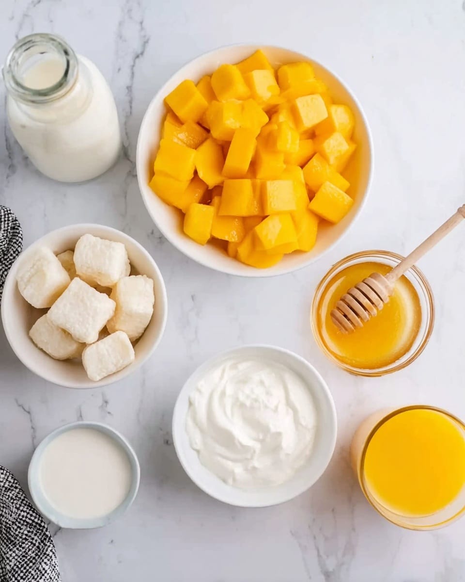 The image shows six white bowls and a glass bottle on a white marbled surface. The largest bowl in the center top is full of bright orange-yellow diced mango cubes with a glossy texture. To the left, a smaller white bowl contains five light beige pieces that look soft and puffy. Beneath it is a glass bottle filled with white milk. At the bottom center, a white bowl holds thick, white cream with a smooth texture. To the right of the cream bowl is a small clear glass filled with orange juice. Near the top right corner, a small white bowl contains golden honey with a wooden honey dipper resting on the bowl’s edge. A corner of a black and white cloth napkin is visible in the bottom left corner. The setting is bright and clean, all on a white marbled surface. Photo taken with an iphone --ar 4:5 --v 7