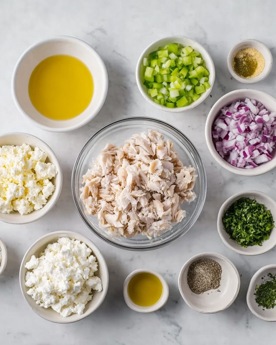 The image shows several small white bowls arranged on a white marbled surface, each containing different ingredients. In the center is a clear bowl filled with finely chopped light beige cooked chicken. Around it are bowls with finely chopped red onion, chopped green celery, white cottage cheese with a lumpy texture, bright yellow olive oil, light yellow lemon juice, off-white yellow mustard, salt, black pepper, and finely chopped green herbs. The bowls are evenly spaced and the colors are soft and fresh, creating a clean and organized look. Photo taken with an iphone --ar 4:5 --v 7
