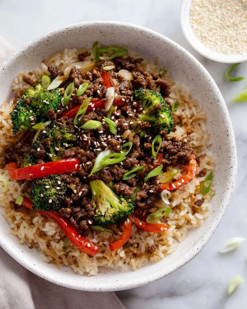The dish is served in a white speckled bowl on a white marbled surface, filled with three main layers. The bottom layer is light brown fried rice with a slightly oily texture. The middle layer has small bright green broccoli florets and strips of red bell pepper scattered evenly. The top layer consists of dark brown ground meat pieces, mixed with finely chopped cooked onions, garnished with white sesame seeds and small green sliced scallions. In the background, there is a small white bowl filled with white sesame seeds. photo taken with an iphone --ar 4:5 --v 7